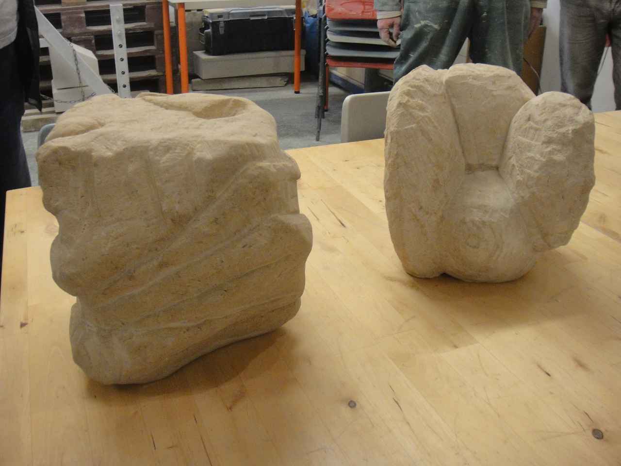 Two stone carvings lying on a table