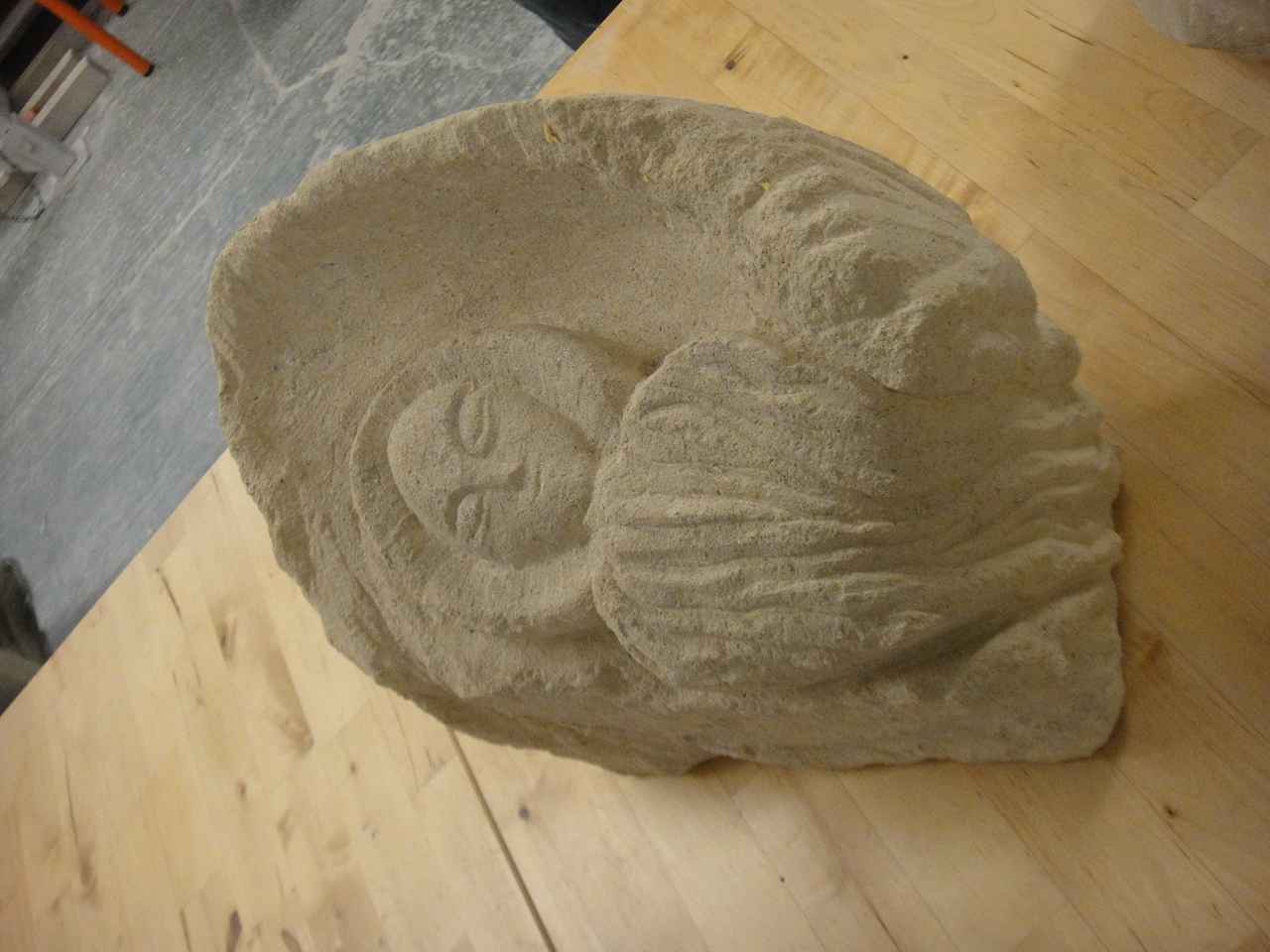 A stone carving lying on a table