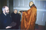 Master Sheng-yen (right) presenting the kesa to Simon Child (left) and Max Kalin (back)